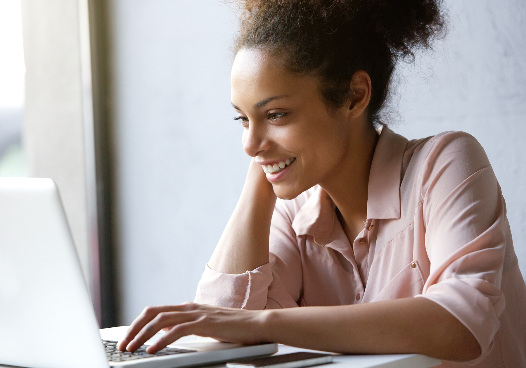 Young woman on a laptop smiling
