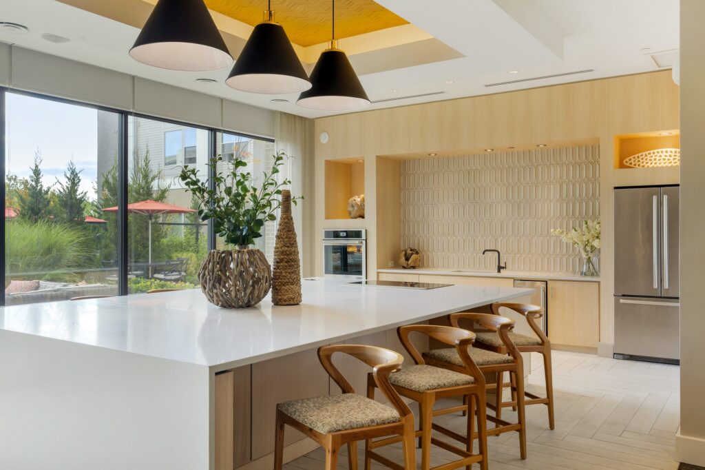Clubhouse with bar seating, kitchen area, pool table and designer lighting