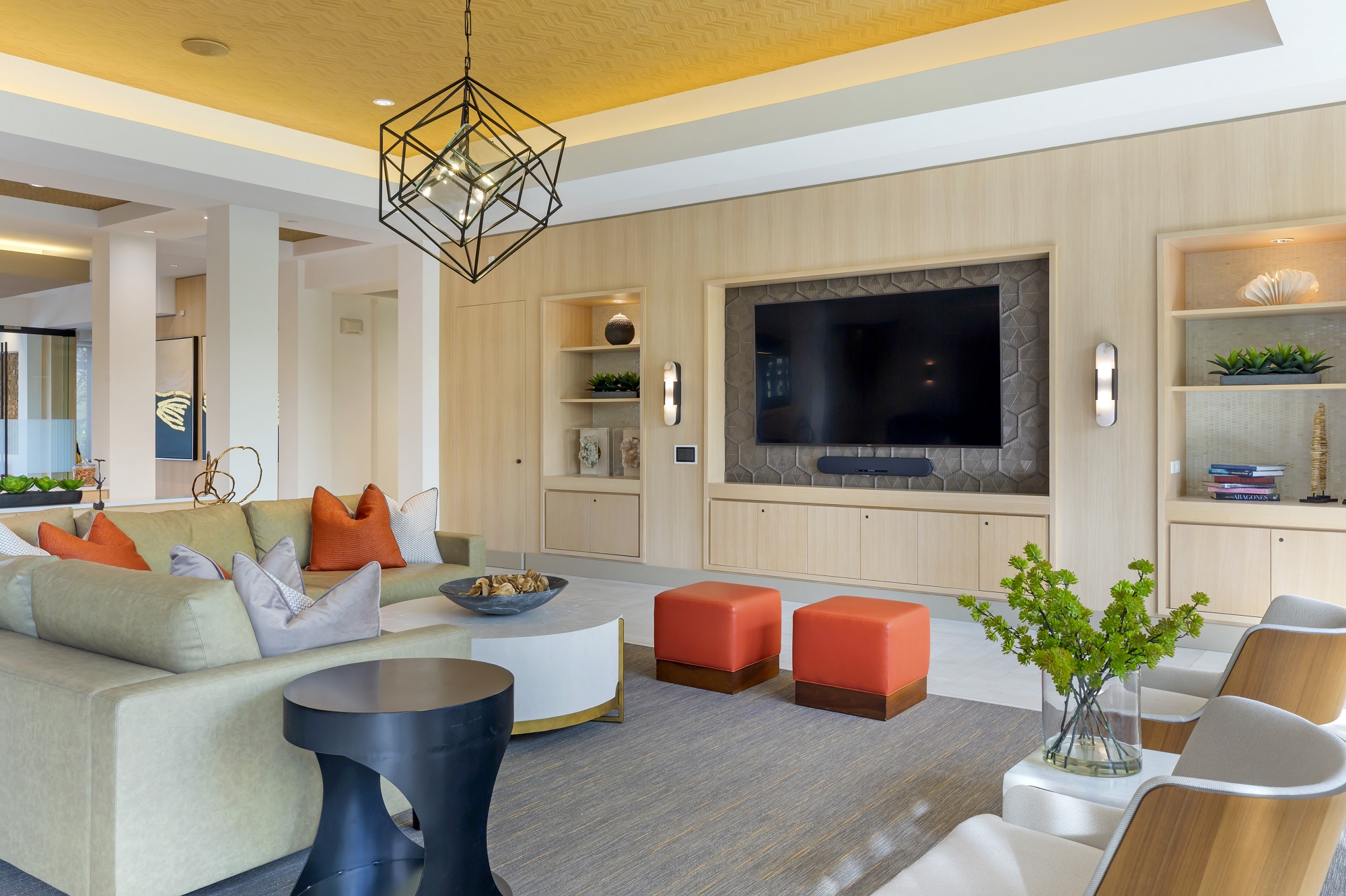 Clubhouse with variety of seating, designer lighting, large flat screen TV, and tile flooring