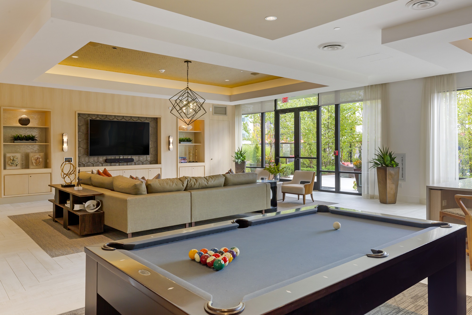 Clubhouse with variety of seating, flat screen TV and pool table