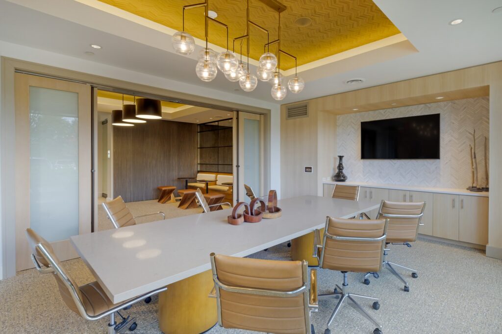 Conference room with designer lighting, conference table and chairs and flat screen TV