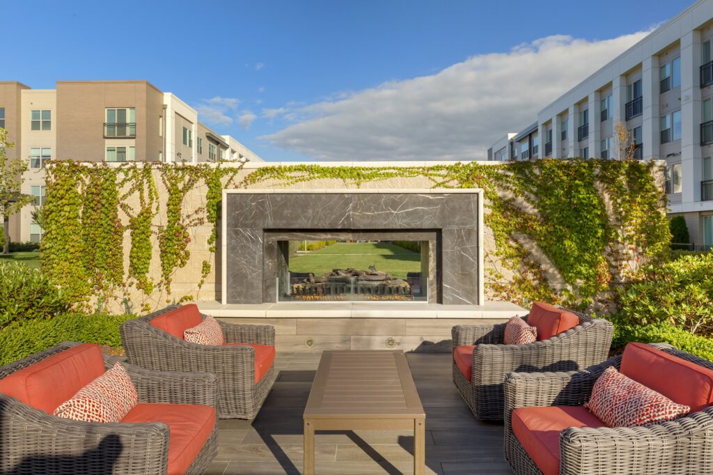 Afternoon shot showing outdoor seating for the clubhouse courtyard with fire pit