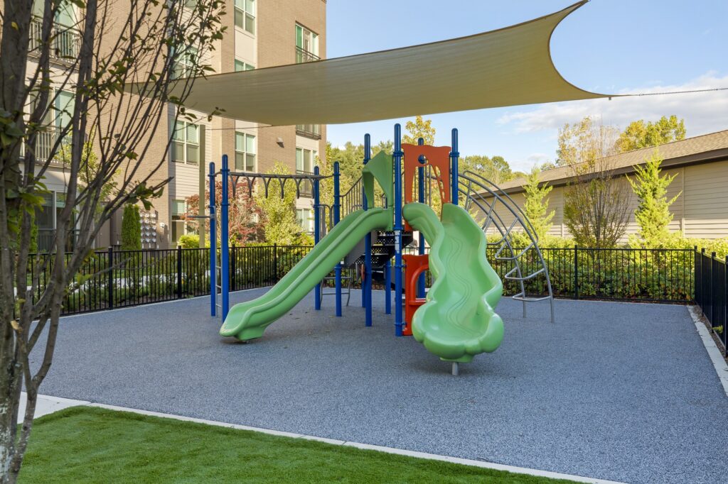Outdoor kids playground area with monkey bars, slides, and stairs