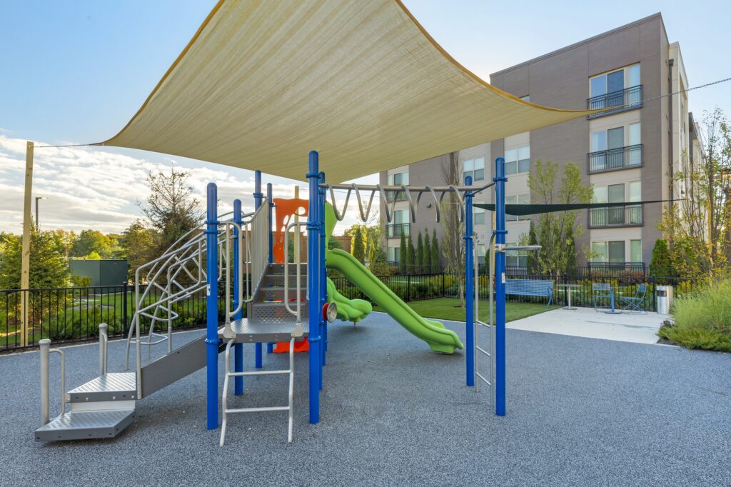 Outdoor kids playground area with monkey bars, slides, and stairs